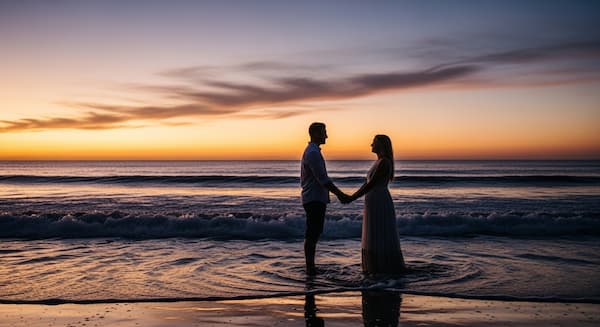 Couple holding hands by the sea under moonlight, symbolizing love and ocean romance.